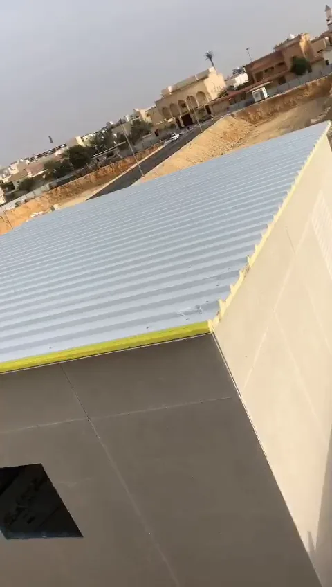 ألواح سقف معدنية مضلّعة مركّبة فوق مبنى منخفض الارتفاع